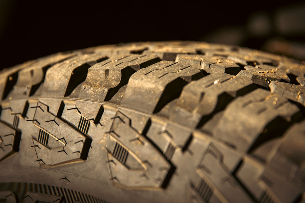 Cooper Discoverer Stronghold A/T — hero tread dirt