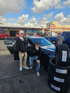 Thermite Tactical customers in Phoenix with a set of Gripmax SureGrip Pro Sport tires, 245/35ZR21 and 265/30ZR21, beside their BMW